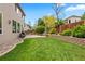 Expansive backyard featuring a well-maintained lawn and stone retaining wall at 12942 Leyden St, Thornton, CO 80602