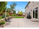 Backyard with a large patio, string lights, and lush landscaping at 12942 Leyden St, Thornton, CO 80602
