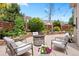Beautiful backyard featuring a fire pit with seating, landscaping, and patio at 12942 Leyden St, Thornton, CO 80602