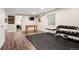 Finished basement with TV, foosball table, workout area, and laminate flooring at 12942 Leyden St, Thornton, CO 80602
