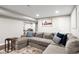 Finished basement featuring a large sectional, cozy rug, and mounted art at 12942 Leyden St, Thornton, CO 80602