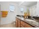 Bright bathroom with a double vanity, granite countertop, and a shower/tub with a patterned curtain at 12942 Leyden St, Thornton, CO 80602