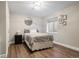 Finished basement bedroom featuring an egress window, vinyl floor, and a cozy bed at 12942 Leyden St, Thornton, CO 80602