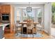 Cozy breakfast nook bathed in natural light, featuring a modern light fixture and views of the backyard at 12942 Leyden St, Thornton, CO 80602