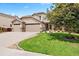 Charming two-story home with a three-car garage and a manicured lawn at 12942 Leyden St, Thornton, CO 80602