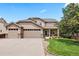 Charming two-story home featuring a three-car garage, well-maintained lawn and mature landscaping at 12942 Leyden St, Thornton, CO 80602