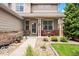 Inviting front porch with brick accents, manicured landscaping, and cozy seating at 12942 Leyden St, Thornton, CO 80602