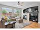 Cozy Gathering room with a fireplace, hardwood floors, and large windows at 12942 Leyden St, Thornton, CO 80602