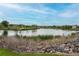 Picturesque lake view surrounded by lush green landscaping and community homes at 12942 Leyden St, Thornton, CO 80602