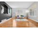 Bright living room boasting hardwood floors, natural light, and stylish decor at 12942 Leyden St, Thornton, CO 80602