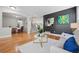 Open living space with hardwood floors, staircase, and elegant archways at 12942 Leyden St, Thornton, CO 80602