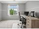 Comfortable home office featuring a large window with tree views and a dark leather office chair at 12942 Leyden St, Thornton, CO 80602
