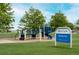 Community playground with blue accents and nearby open green space at 12942 Leyden St, Thornton, CO 80602