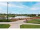 Scenic walking path with a wooden fence near a tranquil community lake at 12942 Leyden St, Thornton, CO 80602