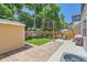 Spacious backyard with well-kept lawn, storage shed, patio, dining set, and privacy fence at 7933 Florado St, Denver, CO 80221