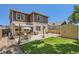 Inviting backyard with a patio, dining set, grill, and a well-maintained lawn with a storage shed at 7933 Florado St, Denver, CO 80221