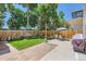 Serene backyard featuring a lush lawn, privacy fence, storage shed, patio, and outdoor seating area at 7933 Florado St, Denver, CO 80221