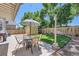 Well-maintained backyard featuring a patio, dining set under an umbrella, manicured lawn and garden at 7933 Florado St, Denver, CO 80221
