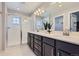 Luxurious bathroom featuring double sinks, quartz countertop, shower, and a sleek design at 7933 Florado St, Denver, CO 80221