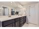 Spacious bathroom with a double sink vanity, modern fixtures, and plenty of cabinet space at 7933 Florado St, Denver, CO 80221