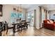 Bright dining area with a modern chandelier, wooden table with seating, and sliding glass doors to the patio at 7933 Florado St, Denver, CO 80221