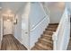 Inviting entryway with hardwood floors and staircase to the upper level of the home at 7933 Florado St, Denver, CO 80221