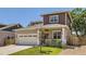 Charming home featuring a well-manicured lawn, an American flag, and a spacious two-car garage at 7933 Florado St, Denver, CO 80221