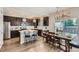 Well-lit kitchen featuring modern stainless steel appliances, stylish countertops and a dining table with chairs at 7933 Florado St, Denver, CO 80221