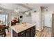 Open-concept kitchen featuring an island, stainless appliances, and seamless flow to the dining and living areas at 7933 Florado St, Denver, CO 80221