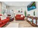 Comfortable living room featuring hardwood floors, a large TV, and plenty of seating at 7933 Florado St, Denver, CO 80221