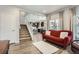 Open-concept living space with stairs, leading to the kitchen and dining areas with lots of natural light at 7933 Florado St, Denver, CO 80221