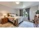 Cozy main bedroom featuring a plush bed, comfortable furnishings, and a serene atmosphere at 7933 Florado St, Denver, CO 80221