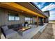 A cozy back porch with comfortable seating and a stylish fire pit, creating an inviting outdoor living space at 65960 E Evans Pl, Byers, CO 80103