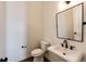 Elegant powder room features a pedestal sink and modern fixtures at 65960 E Evans Pl, Byers, CO 80103