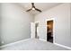 This bedroom offers ample space with a door leading to a bathroom at 65960 E Evans Pl, Byers, CO 80103