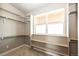 Spacious walk-in closet features built-in shelving and a window for natural light at 65960 E Evans Pl, Byers, CO 80103