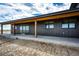 Charming home featuring a covered patio with sturdy wooden pillars and a walkway leading to the backyard at 65960 E Evans Pl, Byers, CO 80103