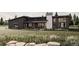 Modern home boasts a clean, contemporary design with striking curb appeal, complete with verdant lawn and rock landscaping at 65960 E Evans Pl, Byers, CO 80103