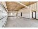 Spacious three car garage with unfinished drywall, ample natural light, and two access doors at 65960 E Evans Pl, Byers, CO 80103