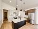 Modern kitchen boasts stainless appliances, granite counters, and stylish pendant lighting at 65960 E Evans Pl, Byers, CO 80103