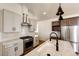 Bright kitchen features stainless steel appliances, granite countertops, and modern fixtures at 65960 E Evans Pl, Byers, CO 80103