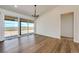 Open living space with hardwood floors, large windows, sliding door, and modern trim at 65960 E Evans Pl, Byers, CO 80103