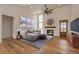 Bright and airy living room with tall ceilings, fireplace, lots of light and hardwood floors at 65960 E Evans Pl, Byers, CO 80103