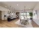 Open concept living space with eat in kitchen, dining area, tall ceilings, and sliding glass door at 65960 E Evans Pl, Byers, CO 80103