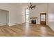 Bright and airy living room with tall ceilings, fireplace, lots of light and hardwood floors at 65960 E Evans Pl, Byers, CO 80103
