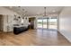 Open concept living space with eat in kitchen, dining area, tall ceilings, and sliding glass door at 65960 E Evans Pl, Byers, CO 80103
