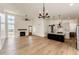Open concept living space with fireplace, eat in kitchen, dining area, and tall ceilings at 65960 E Evans Pl, Byers, CO 80103