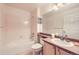 Bright bathroom featuring a shower-tub combination and vanity with sink at 7774 S Biloxi Way, Aurora, CO 80016