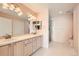 Bright bathroom with dual sink vanity, large mirror, and separate shower at 7774 S Biloxi Way, Aurora, CO 80016