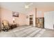 Comfortable bedroom with neutral walls, a ceiling fan, and a doorway leading to the bathroom at 7774 S Biloxi Way, Aurora, CO 80016